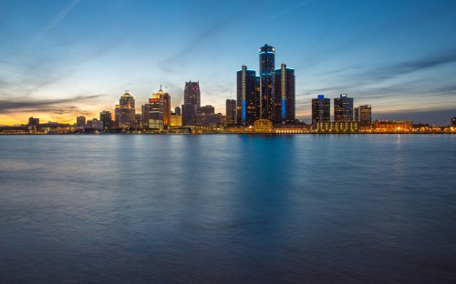 Image city skyline across body of water during daytime