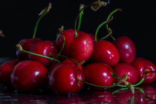 Image red cherry fruit on brown wooden table