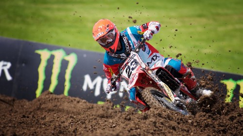 Image man in red and white motocross helmet riding motocross dirt bike