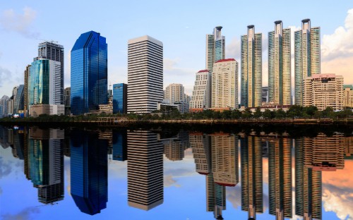 Image high rise buildings near body of water during daytime