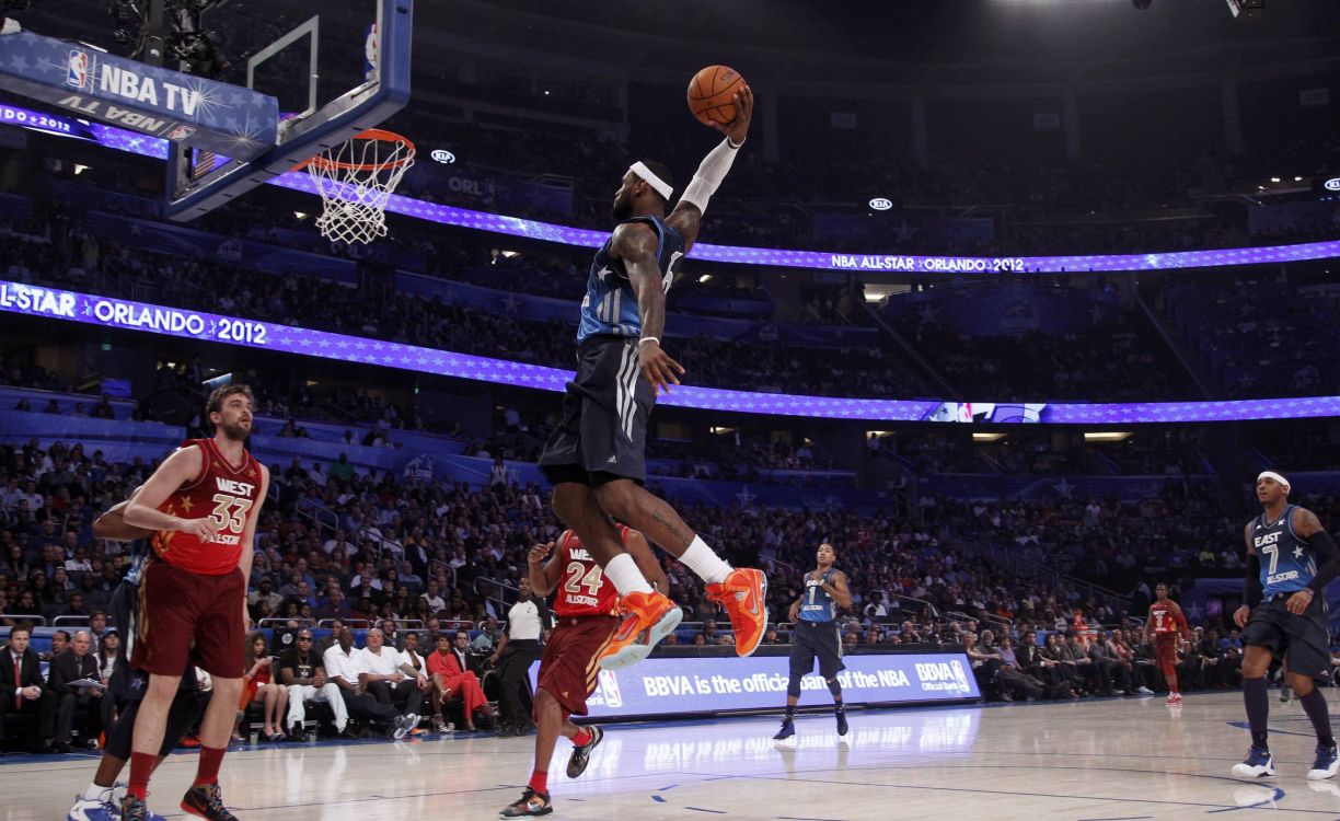 man in black jersey shirt and shorts playing basketball