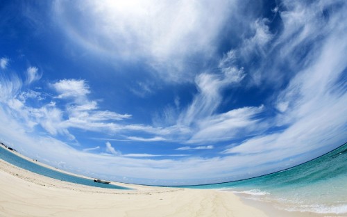 Image white sand beach under blue sky and white clouds during daytime