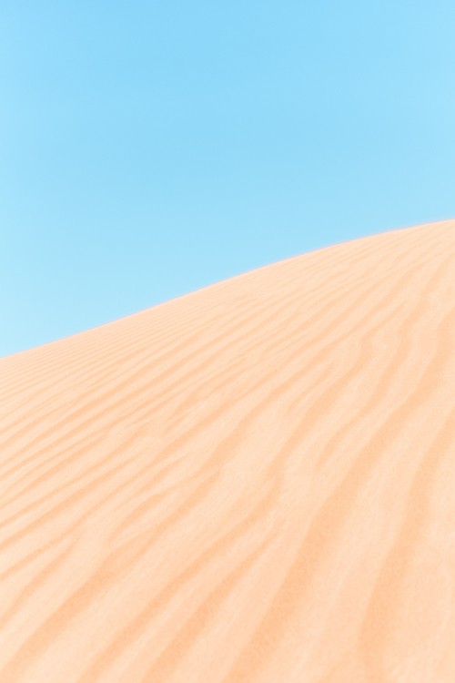 Image brown sand under blue sky during daytime