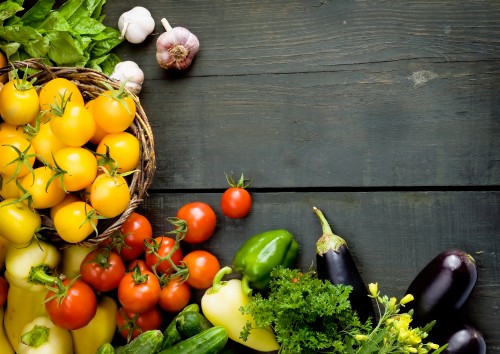 Image yellow red and green bell peppers and garlic on brown wooden table