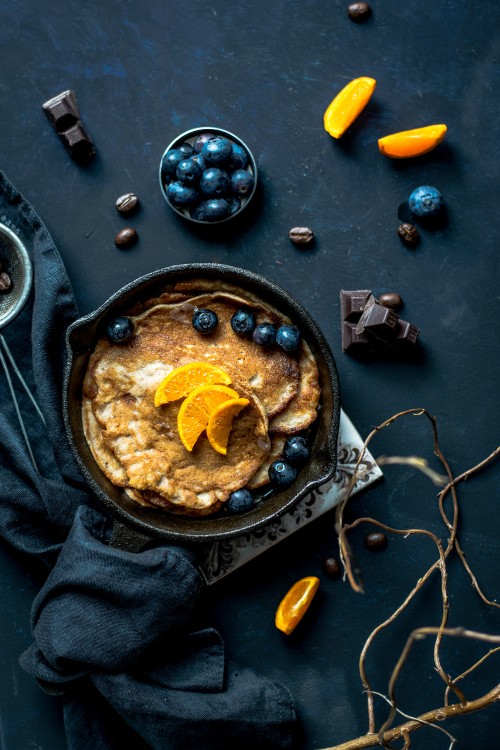 Image black round plate with brown and yellow food