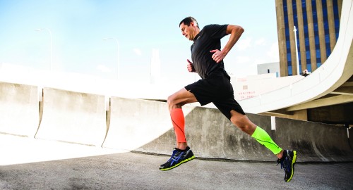 Image man in black t-shirt and black shorts running on gray concrete road during daytime