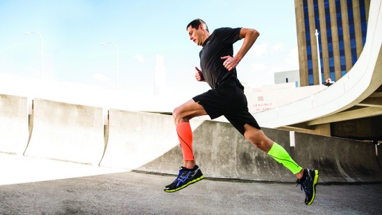 Image man in black t-shirt and black shorts running on gray concrete road during daytime