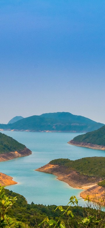 Image green mountains near body of water during daytime