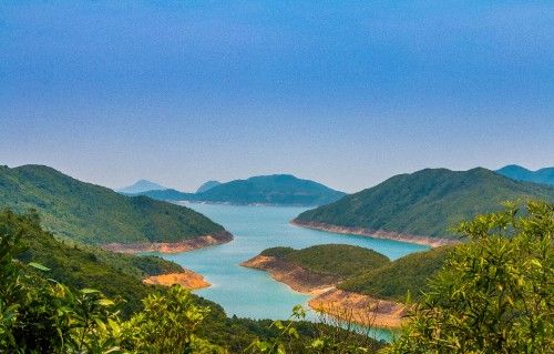 Image green mountains near body of water during daytime