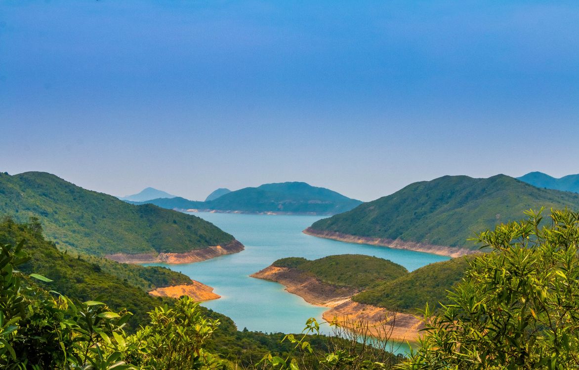 green mountains near body of water during daytime