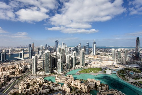 Image city skyline under blue and white sunny cloudy sky during daytime