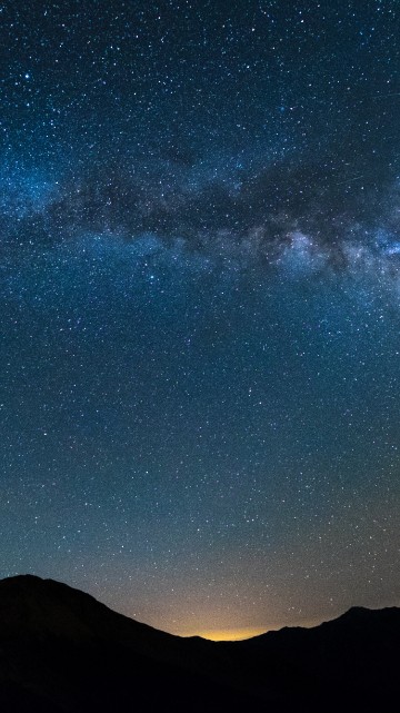 Image silhouette of mountain under blue sky with stars during night time