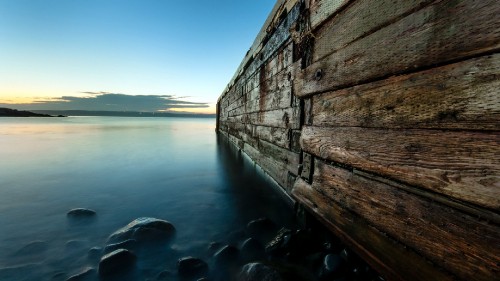 Image brown wooden dock on body of water during daytime