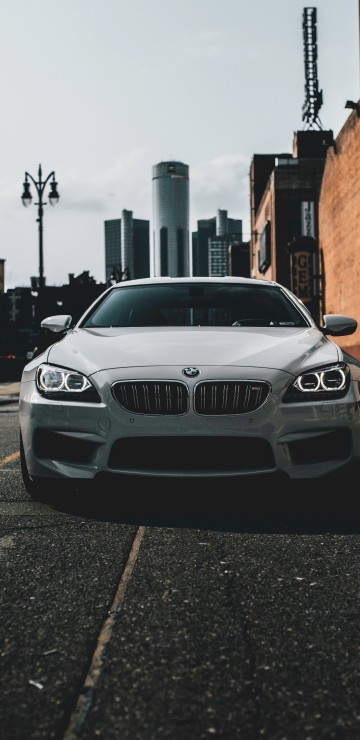 Image white bmw m 3 parked on sidewalk during daytime