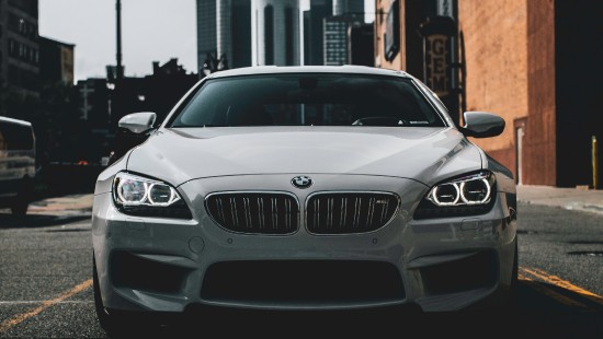 Image white bmw m 3 parked on sidewalk during daytime