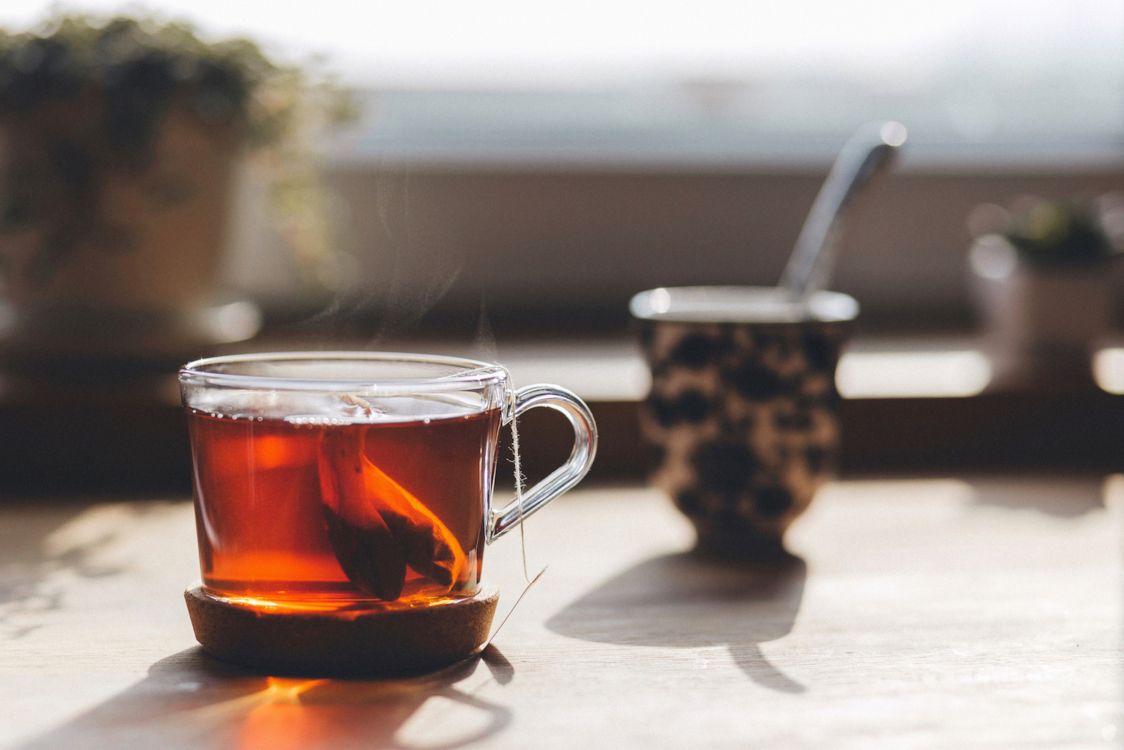 clear glass mug with brown liquid