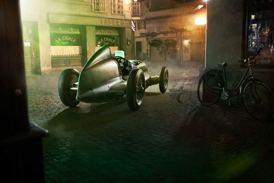 Green and Black Motorcycle Parked Beside Building During Night Time. Wallpaper in 2560x1707 Resolution