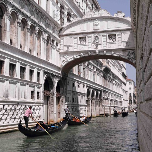 Image people riding on boat on river near white concrete building during daytime