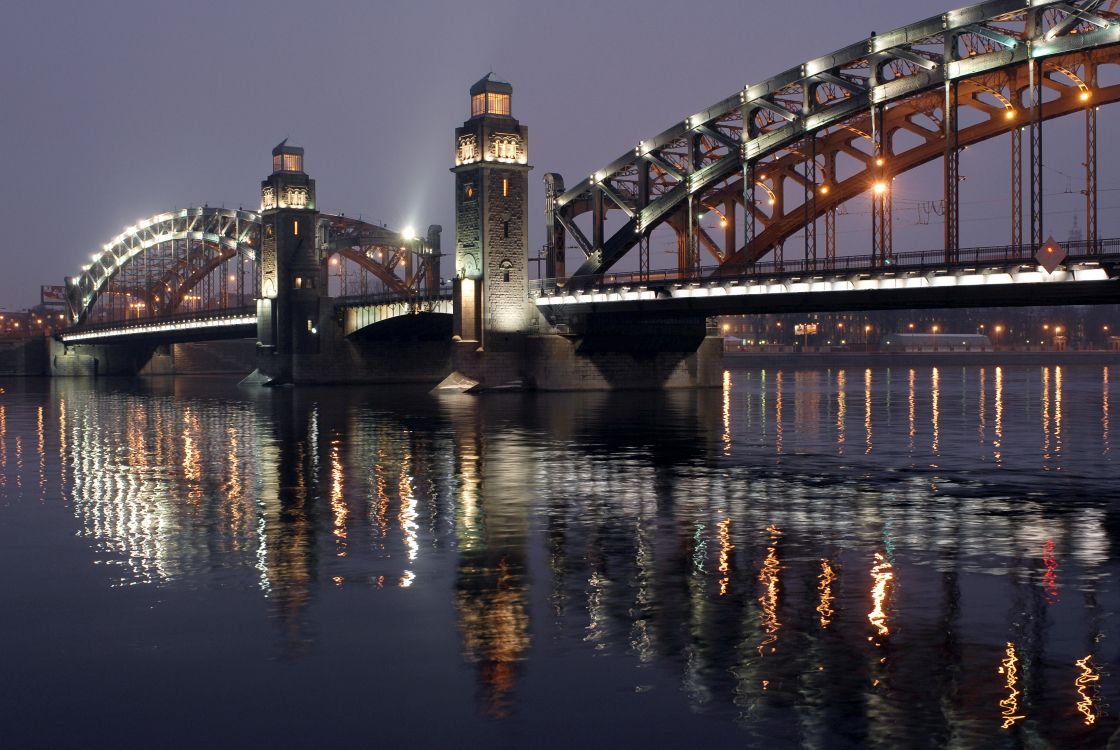 lighted bridge over water during night time