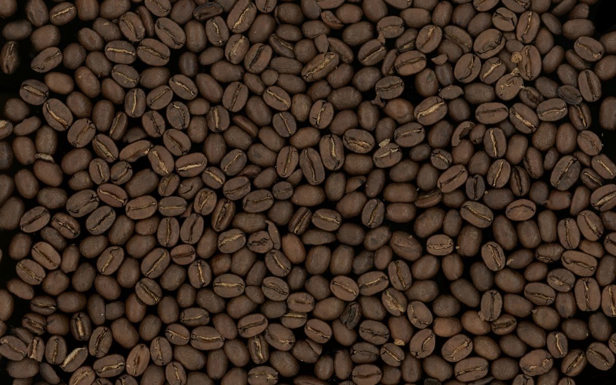 coffee beans on brown wooden surface