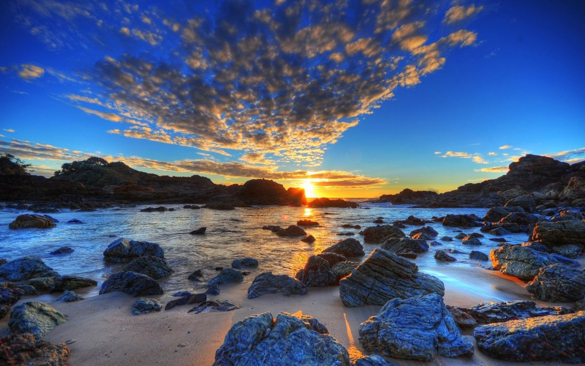 rocky shore with a view of sunset