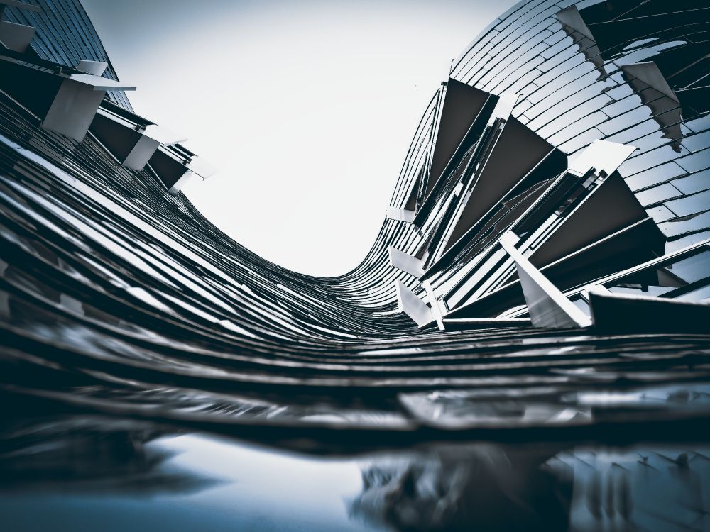 grayscale photo of spiral stairs