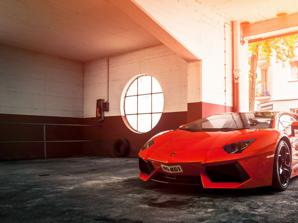 red ferrari sports car parked in garage