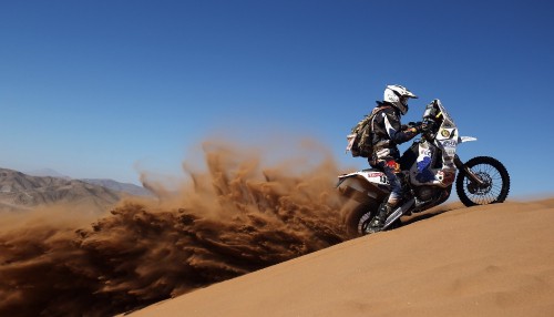 Image man riding motorcycle on desert during daytime