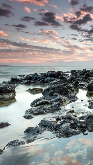 Image rocky shore under cloudy sky during daytime