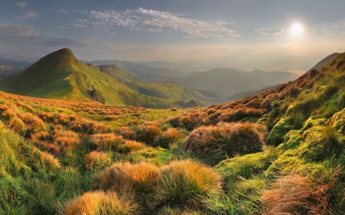 Image green grass field near mountains during daytime