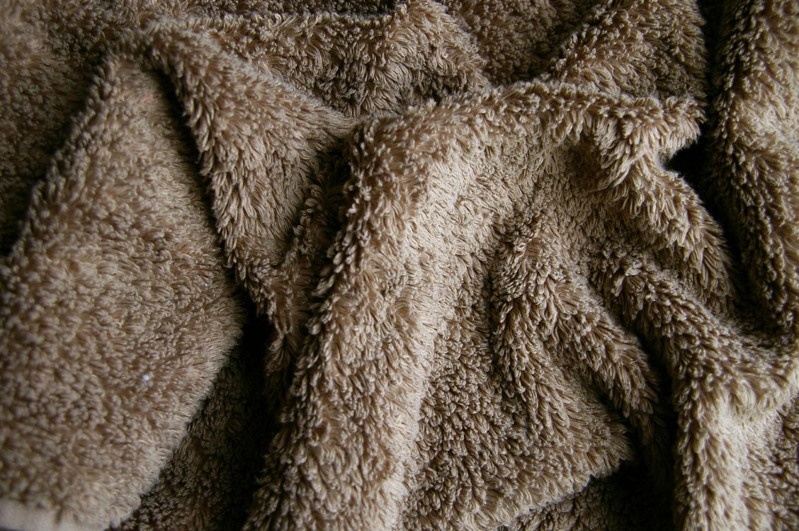 brown and white fur textile