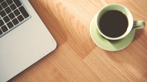 Image white ceramic mug on brown wooden table