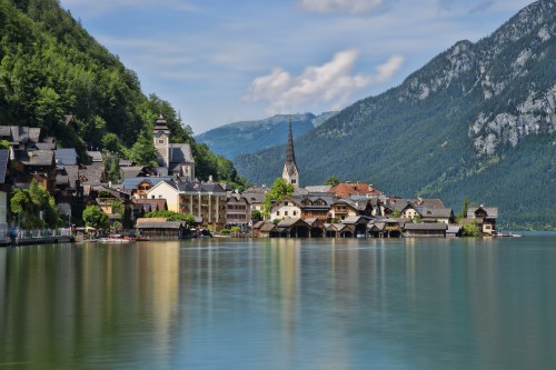 Image houses near lake and mountain during daytime