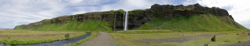 Image waterfalls on green grass field under white clouds during daytime