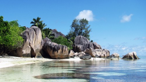 Image gray rock formation near body of water during daytime
