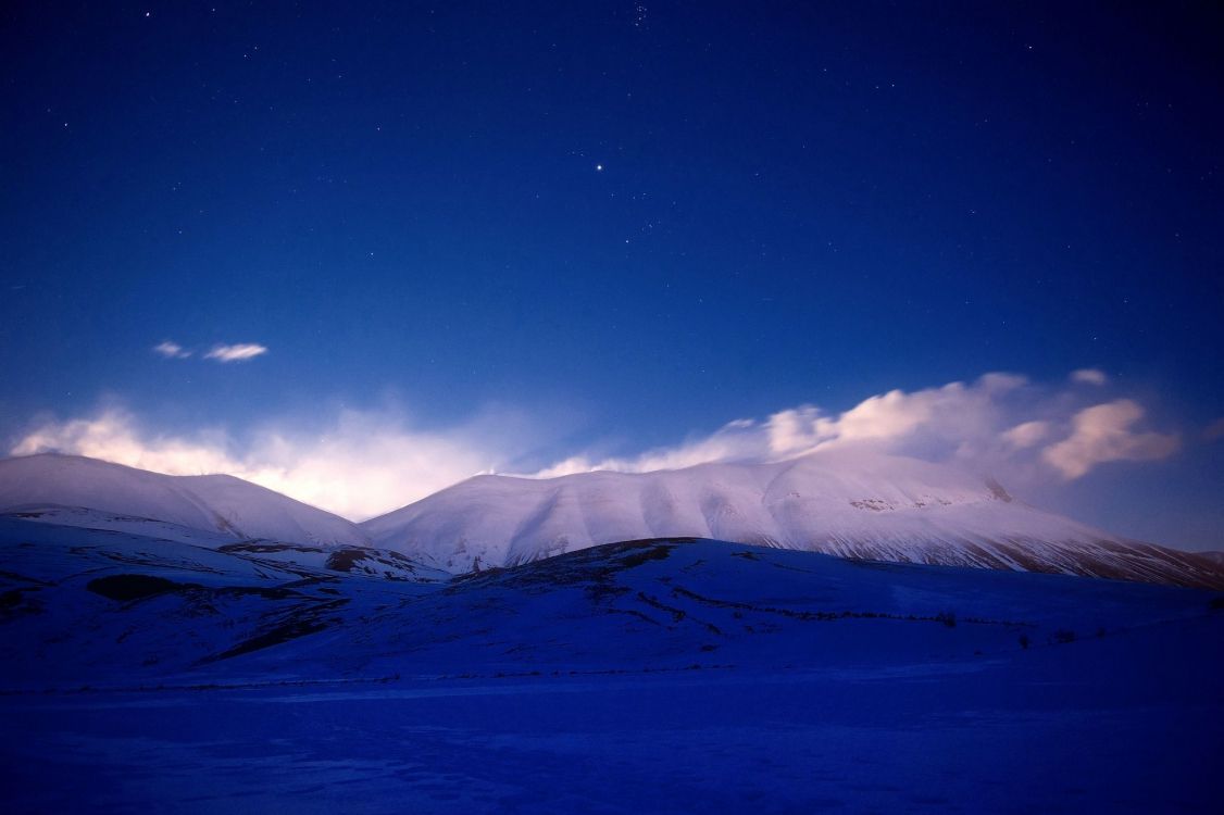 snow covered mountain under blue sky during daytime