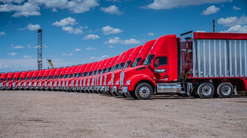 Image red truck on gray asphalt road during daytime