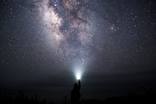 Image silhouette of man and woman standing under starry night