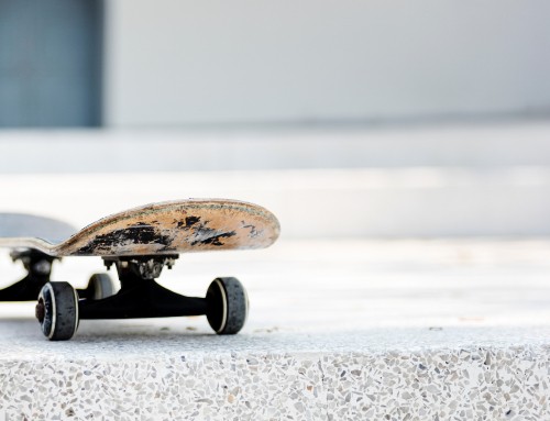 Image brown and black skateboard on gray concrete floor