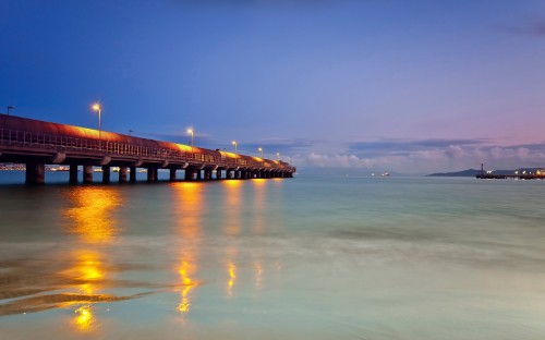 Image brown wooden dock on sea under blue sky during daytime