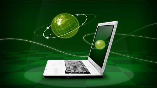 Image green ball on silver laptop computer