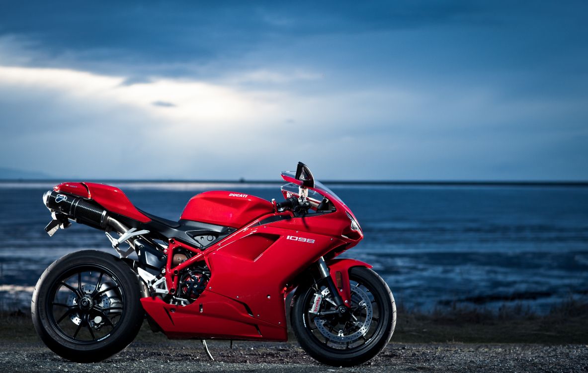 Red and Black Sports Bike on Seashore During Daytime. Wallpaper in 5499x3484 Resolution