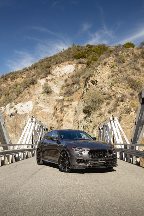 Image black bmw m 3 coupe parked on wooden bridge during daytime