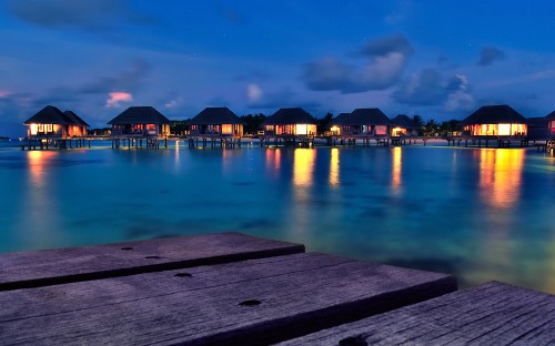 Image brown wooden dock on body of water during night time