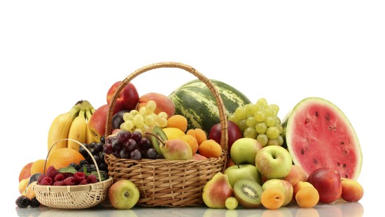 Image green and yellow apples in brown woven basket