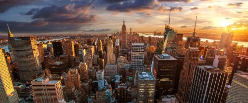 Image aerial view of city buildings during sunset