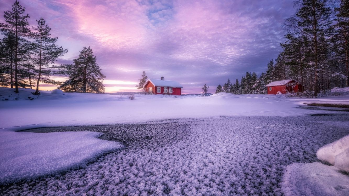 brown wooden house on snow covered ground under gray clouds