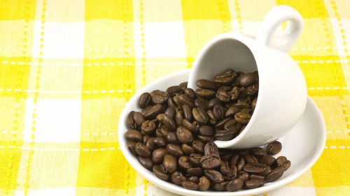 Image coffee beans on white ceramic mug