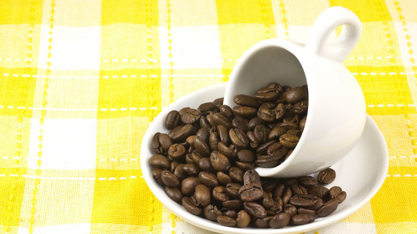 coffee beans on white ceramic mug