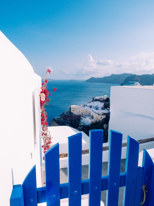 Image white and blue building near body of water during daytime